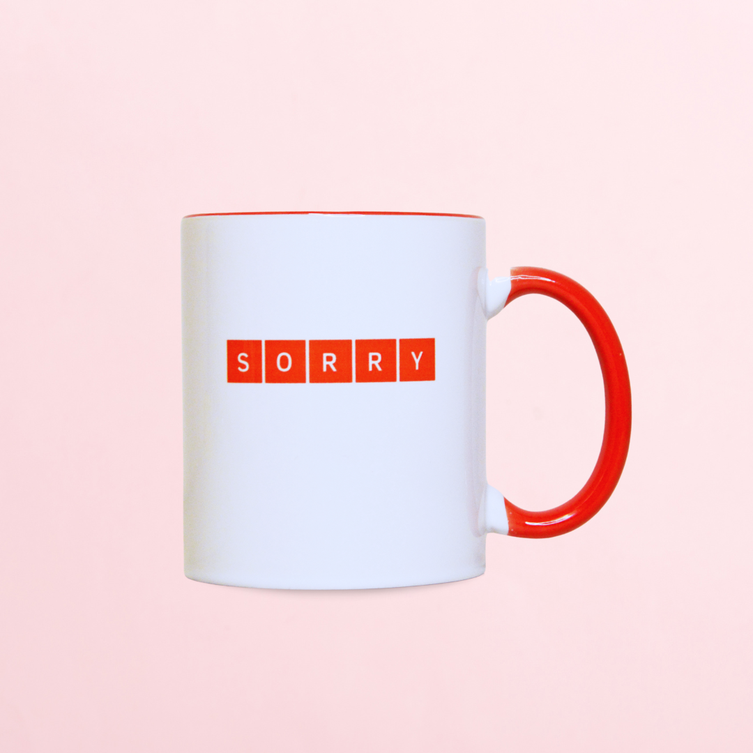 A mug with the word sorry.