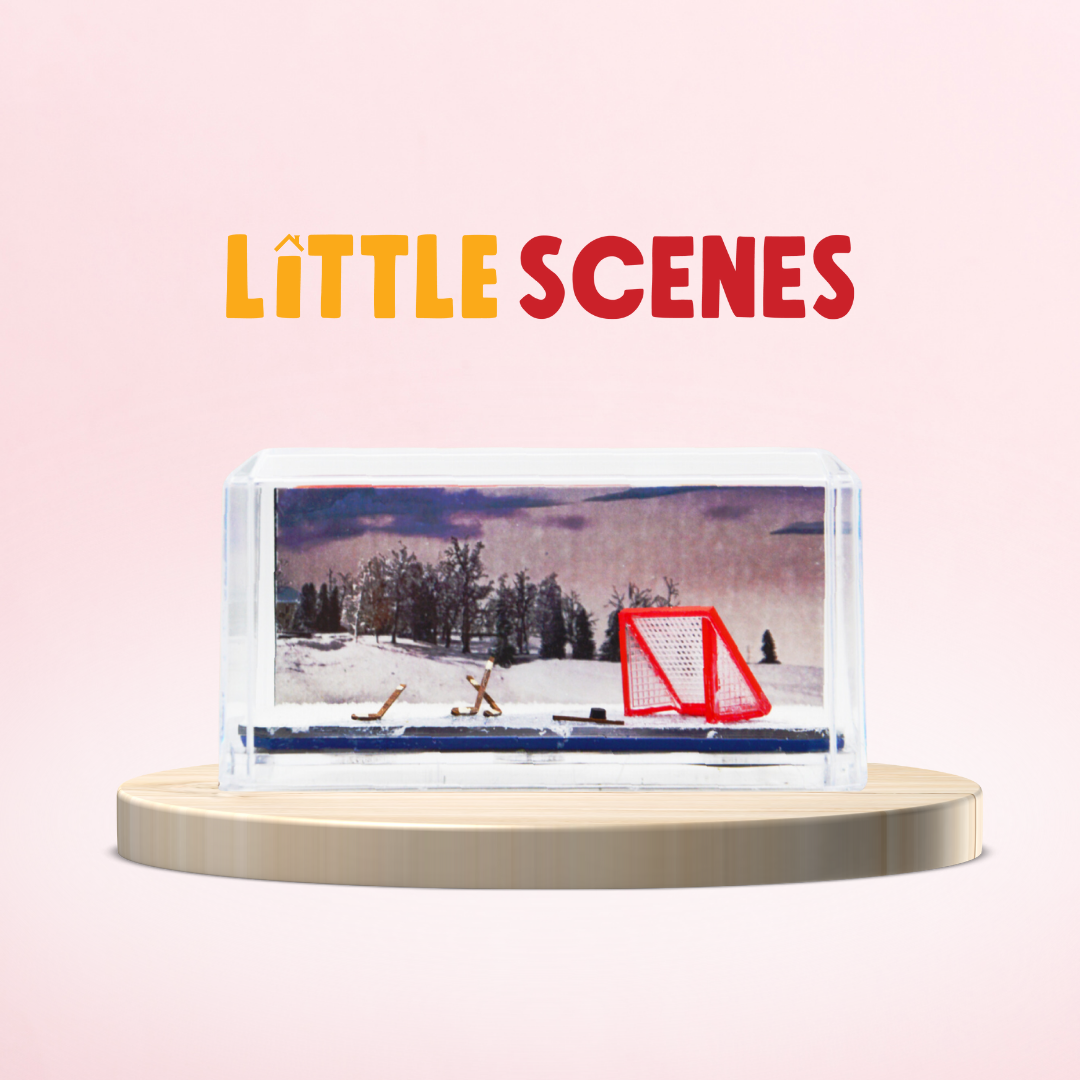 A miniature scene with a hockey net and a winter backdrop.