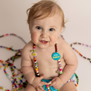 A baby wearing a necklace.