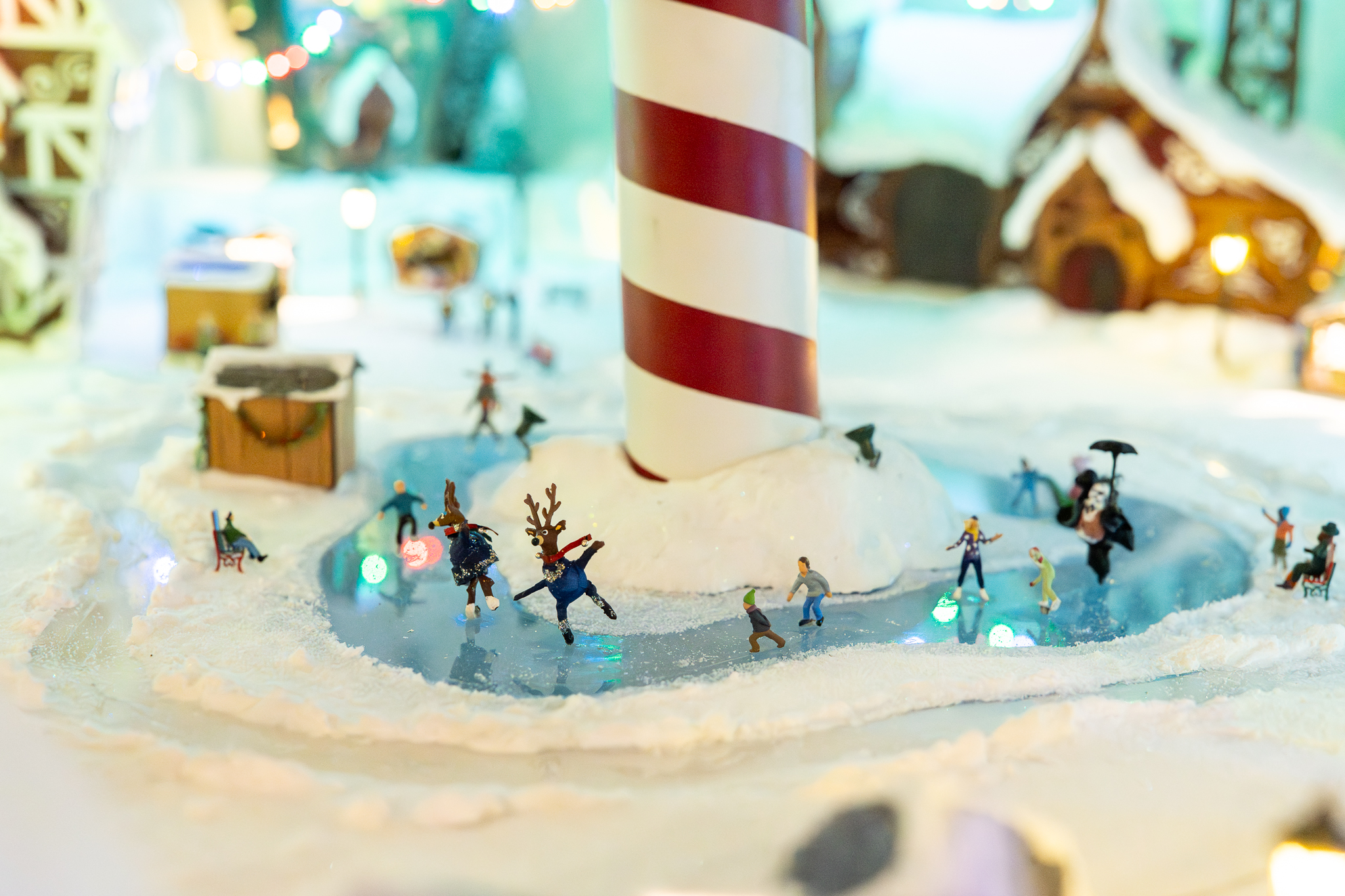 A miniature display of the north pole with a skating rink.