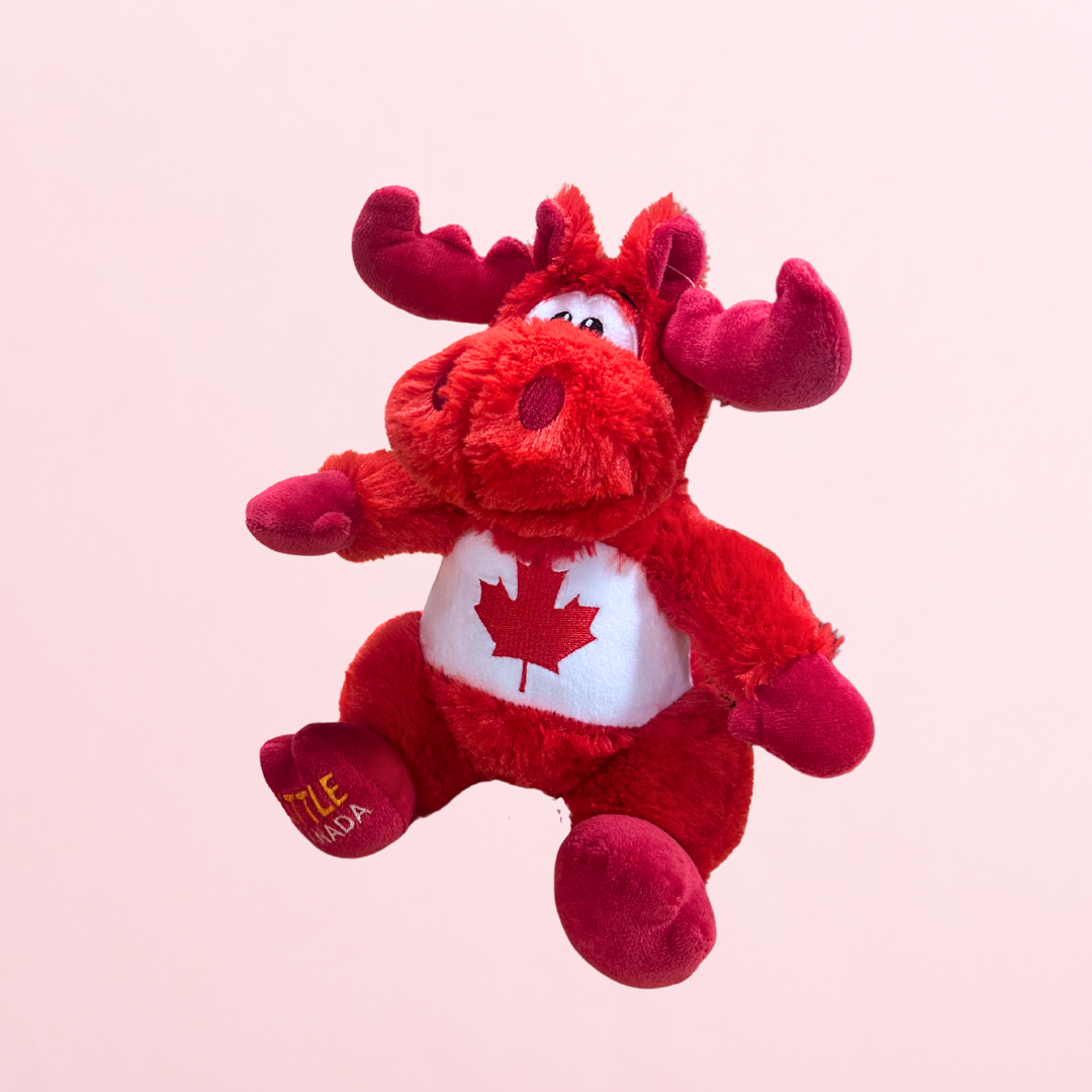 A red and white moose stuffed animal with a maple leaf.