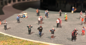 Miniature figures placed into a miniature scene.